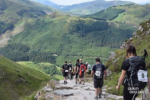 Fundraisers trekking along mountain paths in England.